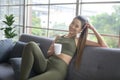 Young fitness woman in sportswear having a cup of coffee after exercising at home, Healthy and Lifestyles