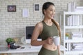 Young fitness woman in sportswear having a cup of coffee after exercising at home, Healthy and Lifestyles Royalty Free Stock Photo