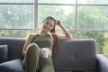 Young fitness woman in sportswear having a cup of coffee after exercising at home, Healthy and Lifestyles