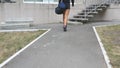 Young fitness woman in sportwear going on stairs up to gym to training. Girl going to health club for workout. Close up