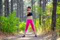 Young Fitness Woman Stretching in the Pine Forest. Female Runner Doing Stretches . Healthy Lifestyle Concept. Royalty Free Stock Photo