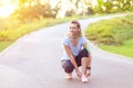 Young fitness woman tie shoelace of sport shoes on city running track Royalty Free Stock Photo