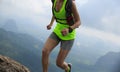 Fitness woman trail runner running at mountain top Royalty Free Stock Photo