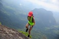 Woman trail runner running at mountain top