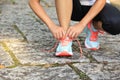 Young fitness woman tying shoelaces Royalty Free Stock Photo