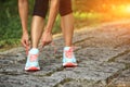 Young fitness woman tying shoelaces