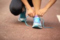 Young fitness woman tying shoelaces Royalty Free Stock Photo