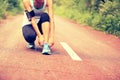 Young fitness woman tying shoelaces Royalty Free Stock Photo