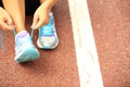 Young fitness woman tying shoelaces Royalty Free Stock Photo