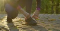 Young Fitness Woman Tying Sneakers Running Shoe Laces in Park.