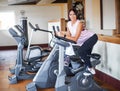 Young fitness woman working out in the gym. Woman working out on exercise bike Royalty Free Stock Photo
