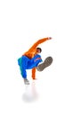 Young flexible sportive man dancing breakdance in vivid orange and blue sport uniform outfit against white studio