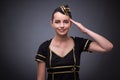 The young flight attendant on gray background Royalty Free Stock Photo