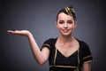 The young flight attendant on gray background Royalty Free Stock Photo