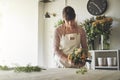 Young florist arranging a mixed flower bouquet in her shop Royalty Free Stock Photo