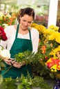 Young florist preparing flowers bouquet shop store Royalty Free Stock Photo