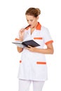 Young focus female doctor or nurse makes notes Royalty Free Stock Photo