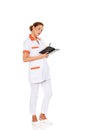 Young focus female doctor or nurse makes notes Royalty Free Stock Photo