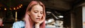 Young focused woman with pink hair working with laptop in cafe Royalty Free Stock Photo