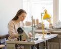 Focused female seamstress sewing clothes at her workplace Royalty Free Stock Photo