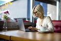 Young Focused Woman Working On Laptop In Cafe Royalty Free Stock Photo