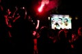 Young football fans watching football match on the street screen