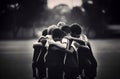 Young football players in a huddle black and white monochrome