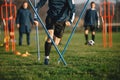 Young Football Players Running Slalom and Jumping Over Poles Royalty Free Stock Photo