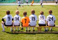 Young Football Players. Young Soccer Team Sitting on Wooden Bench