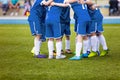 Young football soccer players in blue sportswear. Young sports team