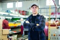 Young foreman of fruit factory standing on citrus sorting line Royalty Free Stock Photo