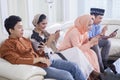 Four Muslim people using a phone on the couch Royalty Free Stock Photo