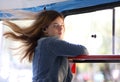 Young freckled girl enjoying trip at public transport