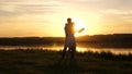 Young free couple dancing at sunset on beach. Happy guy and girl waltz in evening in a summer park. Enamored man and Royalty Free Stock Photo