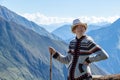 Young free woman travel alone in Andes mountains in Peru. Landscape with solo female tourist, mountains and copy space