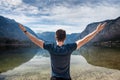 Young freedom man hands up on a mountain lake Royalty Free Stock Photo