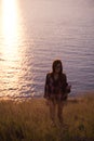 Young freedom woman enjoy ocean sunset on mountain peak Royalty Free Stock Photo