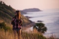 Young freedom woman enjoy ocean sunset on mountain peak