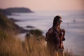 Young freedom woman enjoy ocean sunset on mountain peak Royalty Free Stock Photo