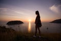 Young freedom woman enjoy ocean sunset on mountain peak