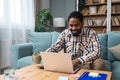 Young freelance business man or exchange student working remotely from his home office on laptop computer. African American work Royalty Free Stock Photo