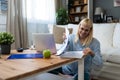 Young freelance business woman working at home on laptop as product strategy expert. Female expatriate remote work on internet on Royalty Free Stock Photo