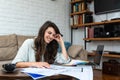 Young freelance interior designer woman working at home office on new project. Business owner female architect checking solutions Royalty Free Stock Photo