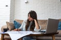 Young freelance interior designer woman working at home office on new project. Business owner female architect checking solutions Royalty Free Stock Photo