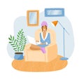 Young freelancer woman working from home in a bathrobe with a towel on her head and patches on her face. Concept of