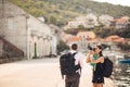 Young freelancing photographers enjoying traveling and backpacking.Photojournalism.Documentary travel photos.Lightweight travel