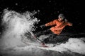 Young freeride snowboarder jumping in snow at night Royalty Free Stock Photo