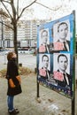 Young French woman admiring the electoral posters of Benoit Hamon