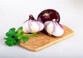 Whole red flat onion and half an onion on a cutting Board, isolated on a white background