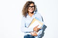 Young friendly curly latin business woman with books in hands isolated white background